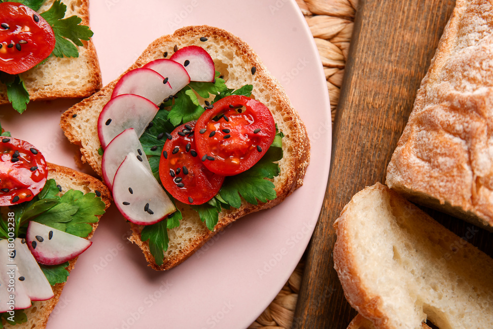 Plate with delicious radish bruschettas on pink tiled table