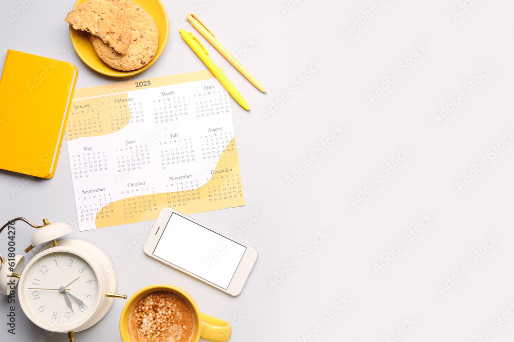 Composition with calendar, mobile phone, alarm clock, cup of coffee and cookies on grey background