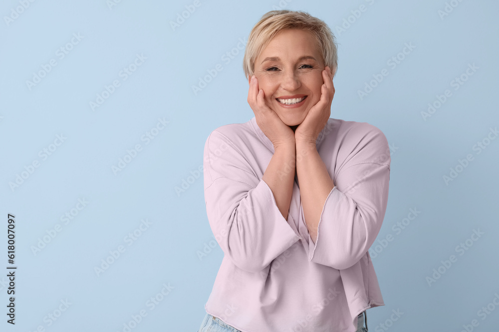 Mature blonde woman on blue background