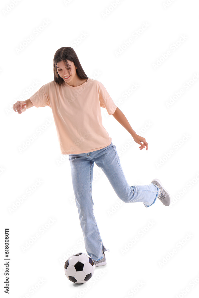 Young woman playing with soccer ball on white background