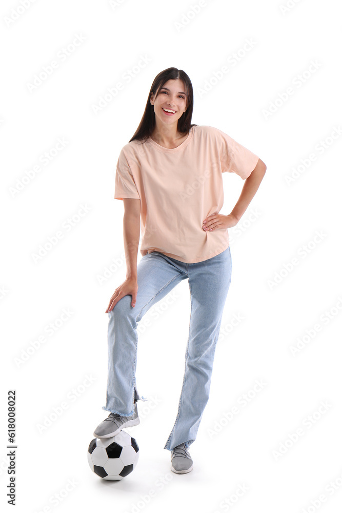 Young woman with soccer ball on white background