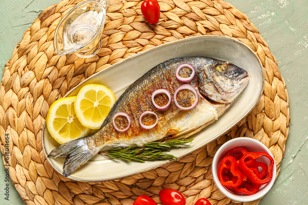 Plate with tasty grilled dorado fish on grey background