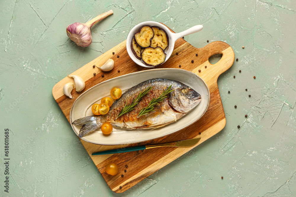 Plate with tasty grilled dorado fish on grey background