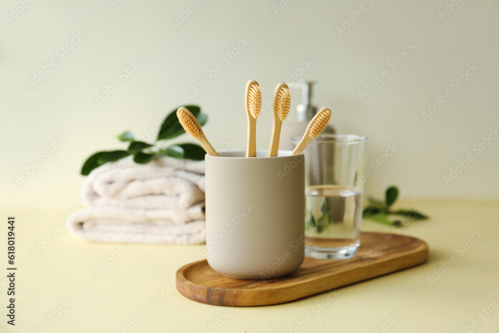 Holder with bamboo tooth brushes in bathroom