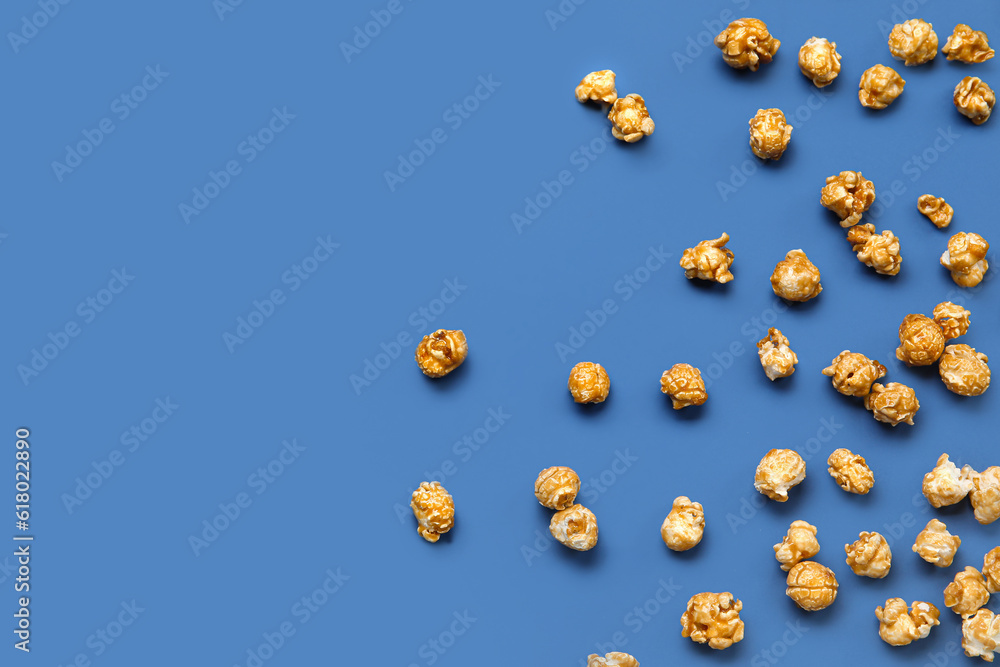 Tasty popcorn on blue background