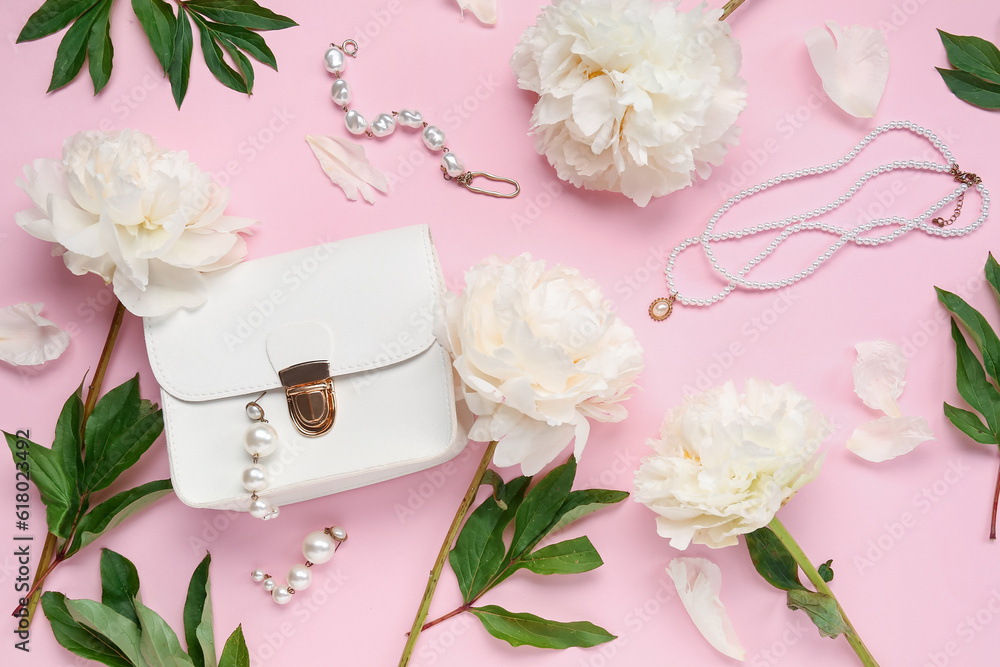 Composition with beautiful female accessories, bag and peony flowers on pink background