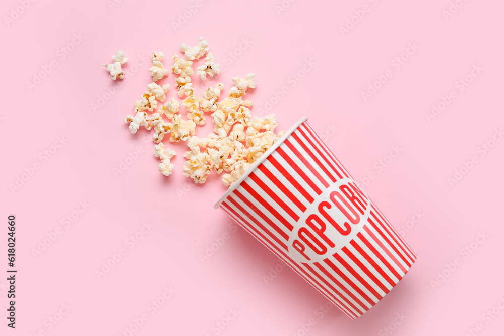 Bucket with tasty popcorn on pink background