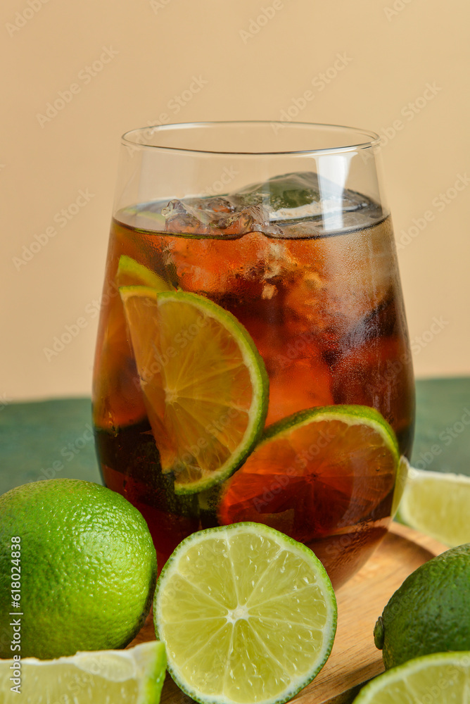 Glass of cold Cuba Libre cocktail on table