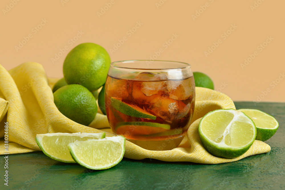 Glass of cold Cuba Libre cocktail on table