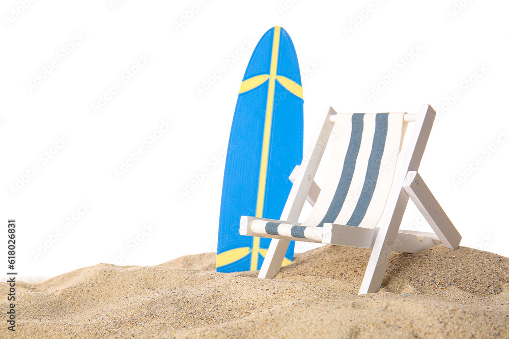 Mini surfboards with deckchair on sand against white background