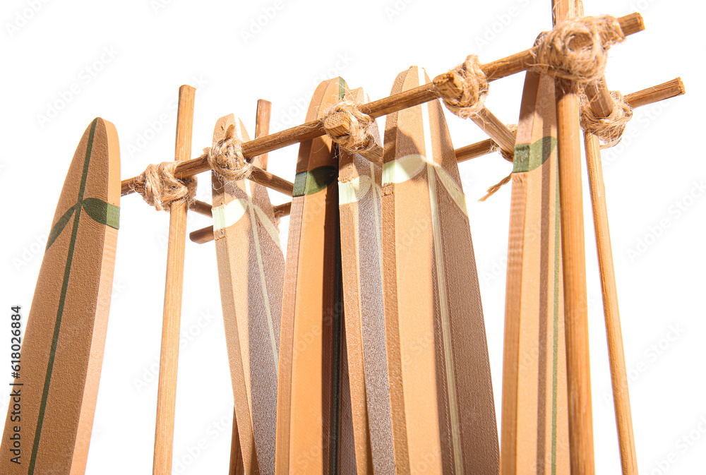 Stand with different mini surfboards isolated on white background