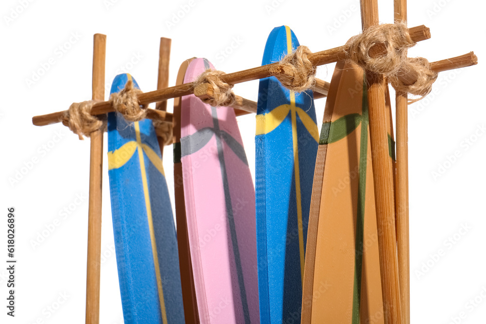 Stand with different mini surfboards isolated on white background