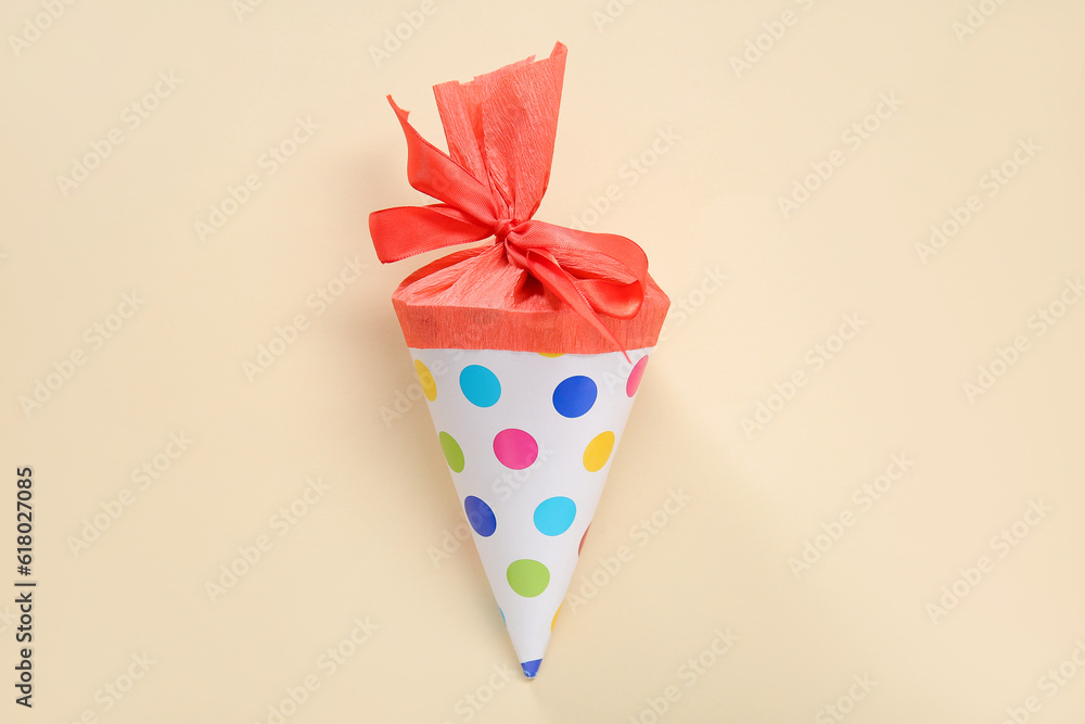 Red school cone on pale orange background