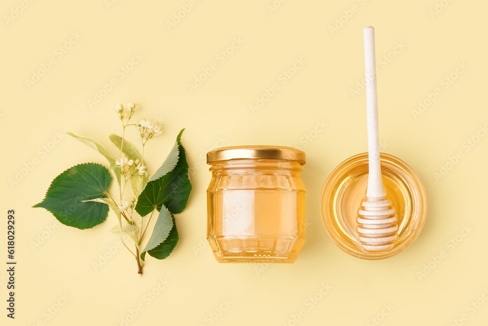 Glass bowl and jar with linden honey on yellow background