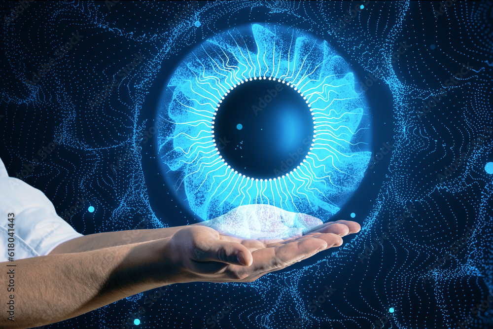 Close up of male hands holding abstract digital blue eye iris on blurry tech background. Technology 