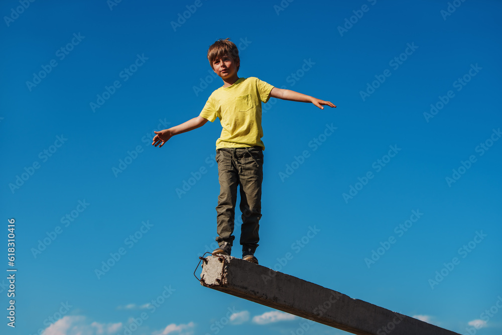 Boy walking and balancing on blue sky backgrounds