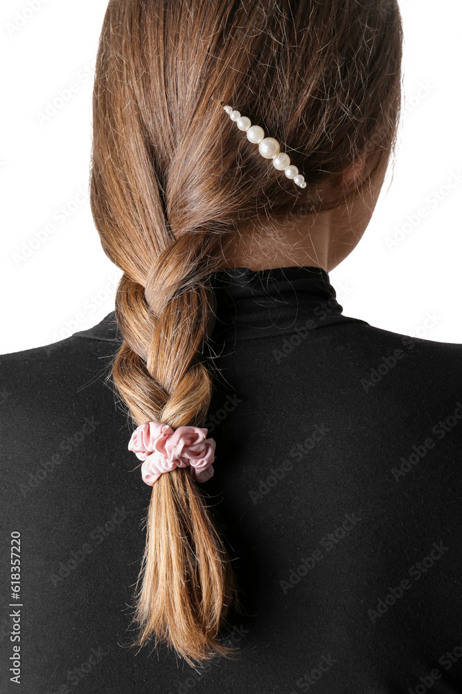 Woman with pigtail and silk scrunchy on light background, back view