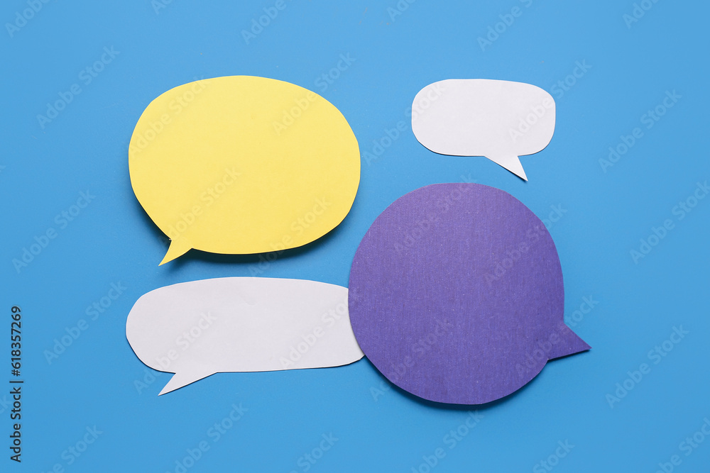 Blank paper speech bubbles on blue background