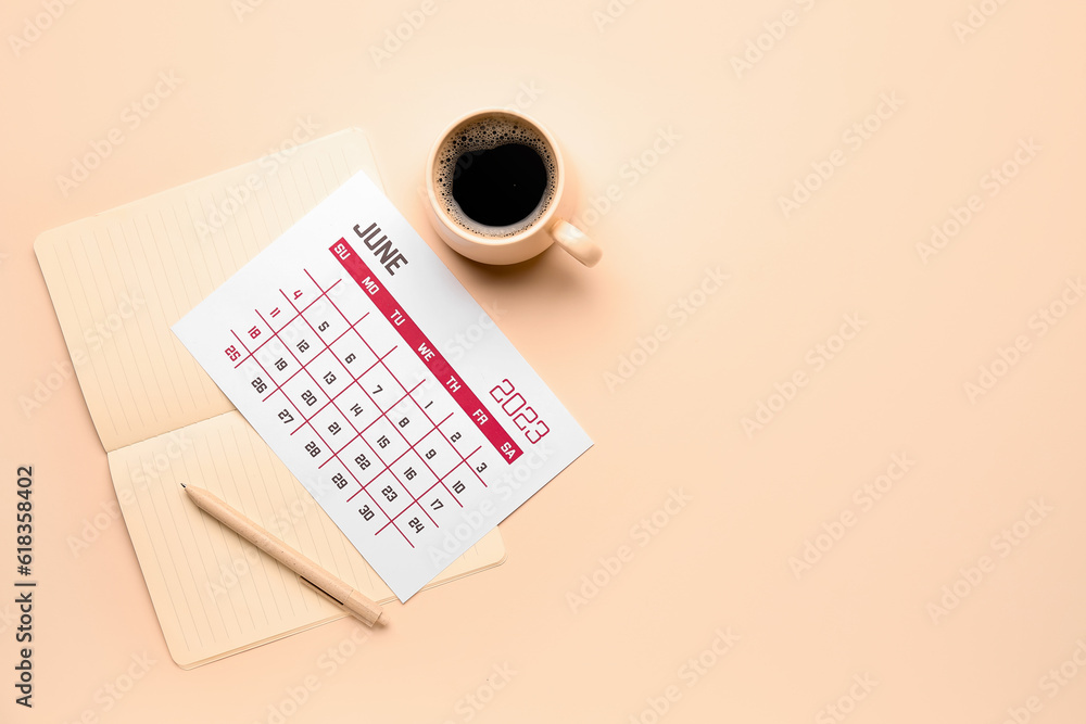 Calendar, notebook, pen and cup of coffee on beige background