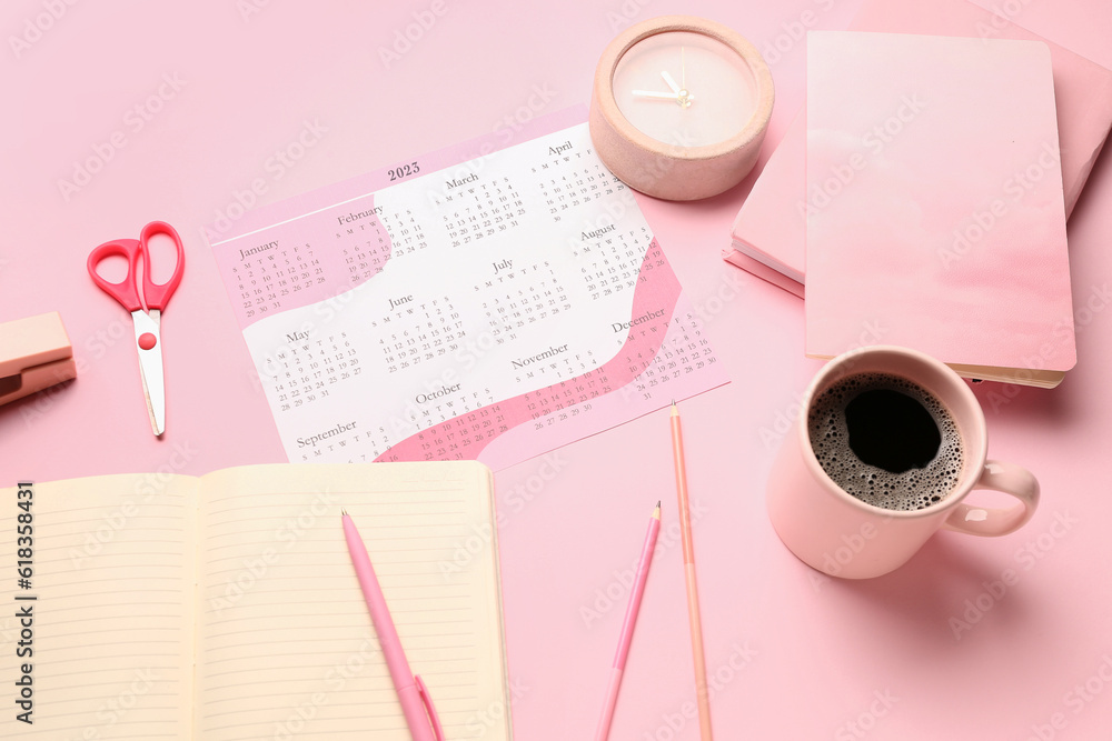 Composition with calendar, cup of coffee, alarm clock and stationary on pink background