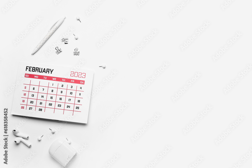 Composition with calendar, earphones and stationary on white background