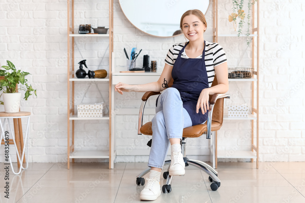 Female hairdresser sitting in beauty salon