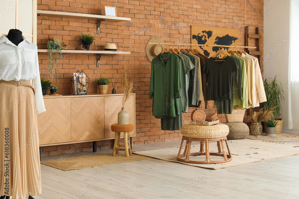 Interior of modern boutique with stylish female clothes and accessories