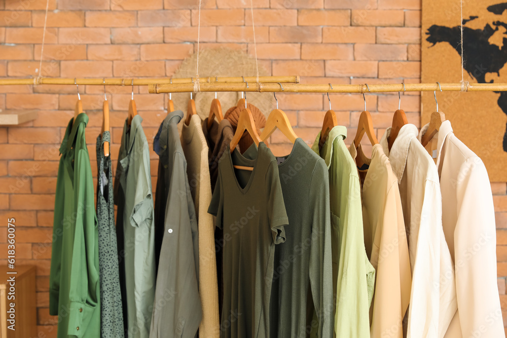 Rack with stylish female clothes in boutique