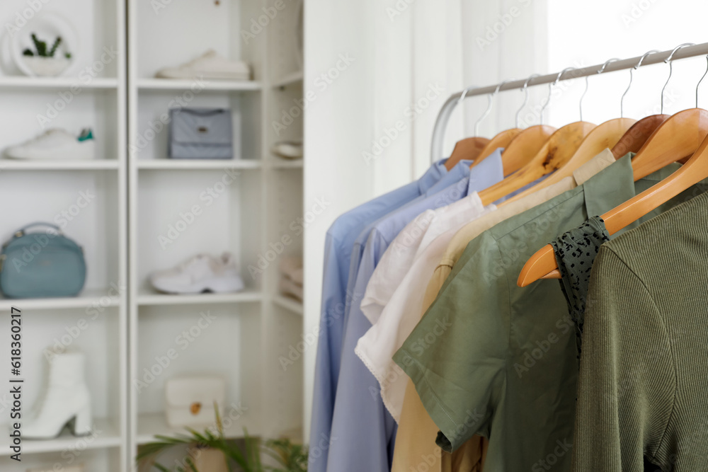 Rack with stylish female clothes and accessories in boutique, closeup