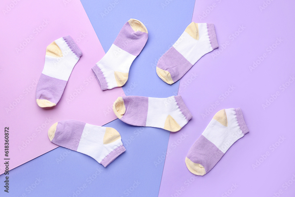 Many cotton socks on color background