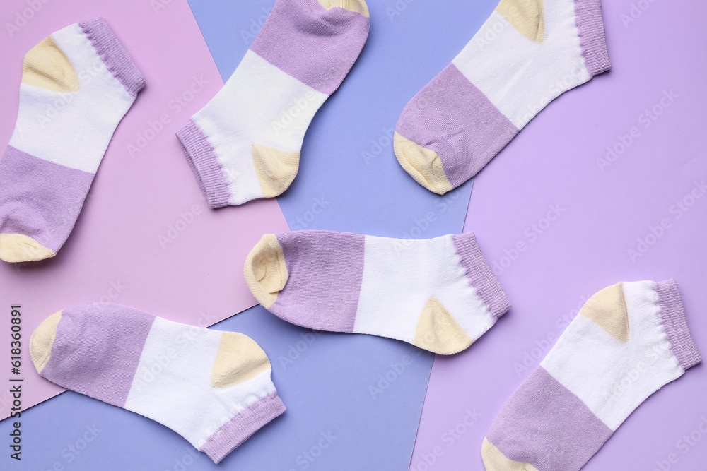 Many cotton socks on color background