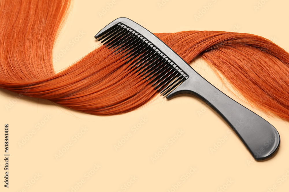 Ginger hair strand with comb on color background, closeup