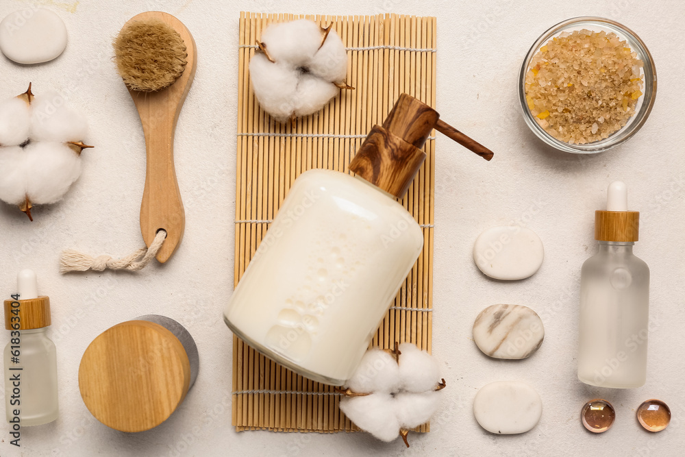 Composition with cosmetic products, bath supplies and cotton flowers on light background, closeup