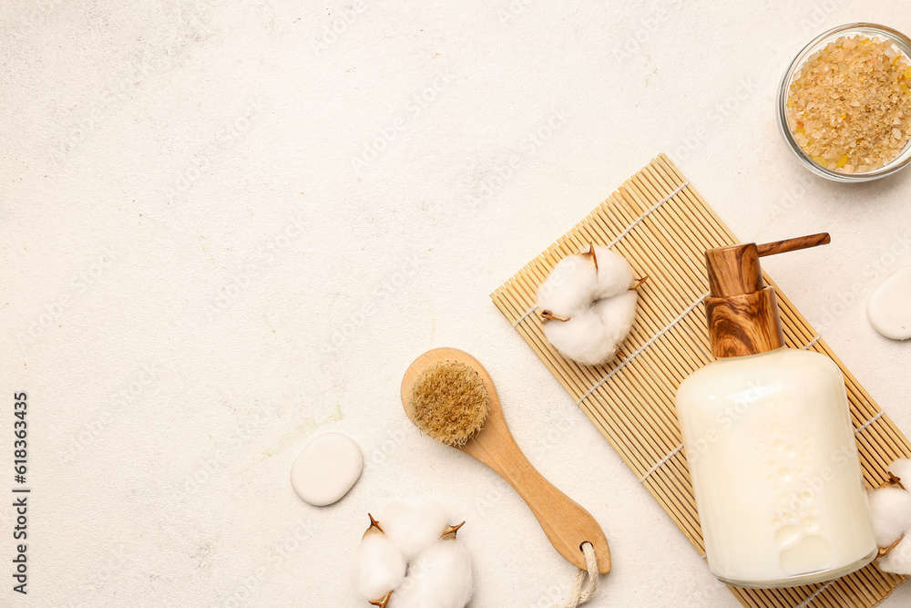 Composition with bath supplies and cotton flowers on light background