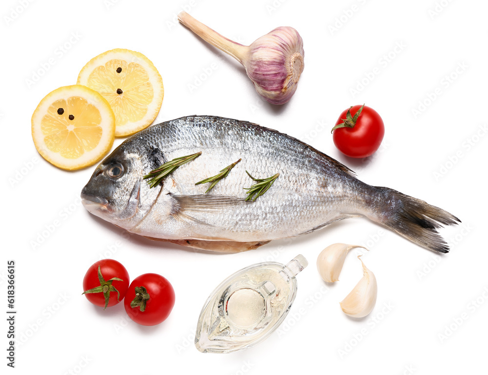 Raw dorado fish with lemon and vegetables on white background