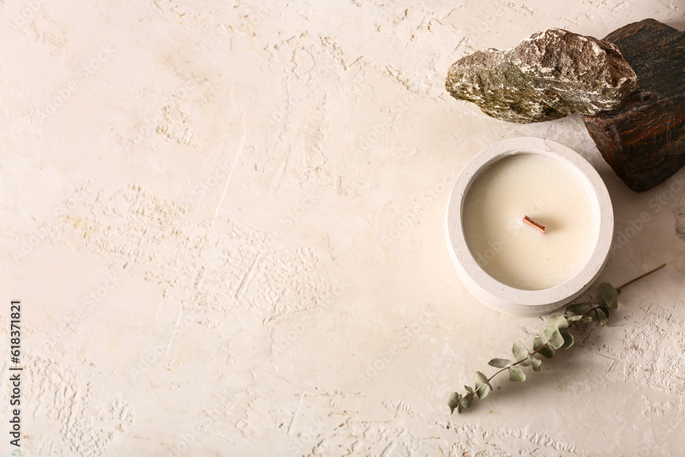 Holder with candle and stones on white background