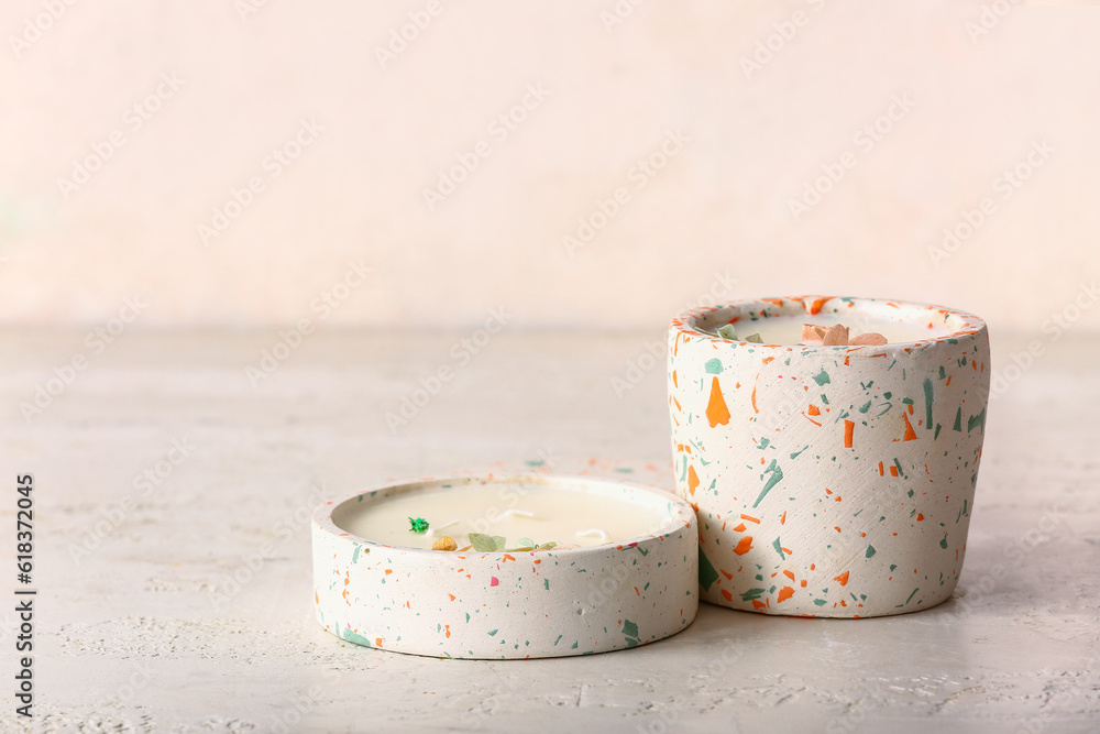 Holders with candles on white background