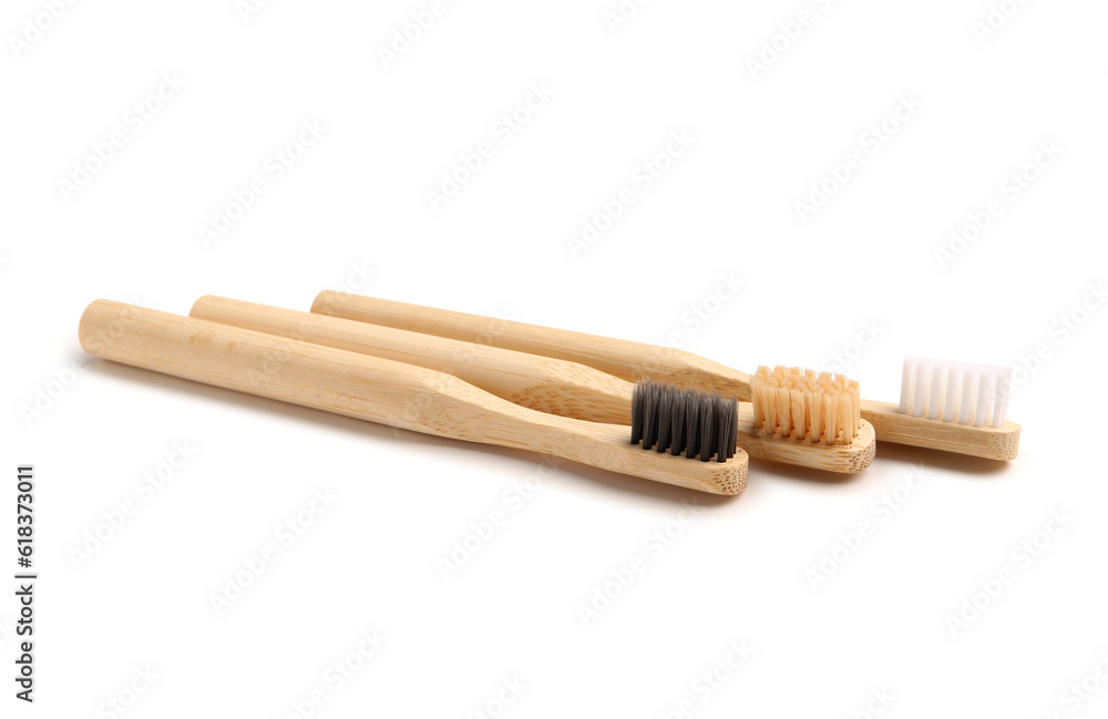 Bamboo tooth brushes on white background