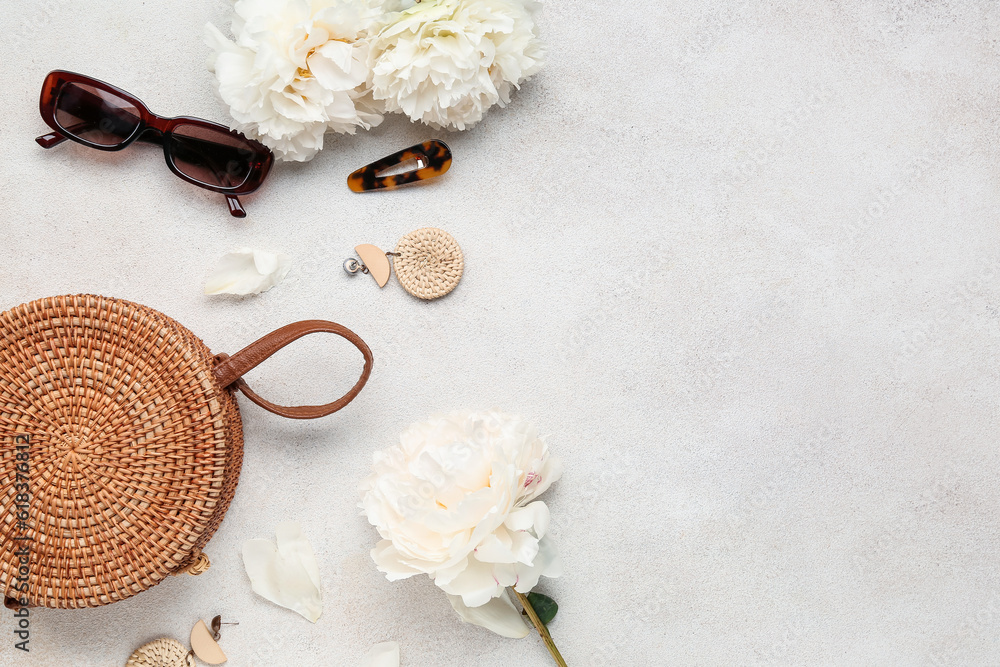 Composition with stylish female accessories and aromatic peony flowers on light background