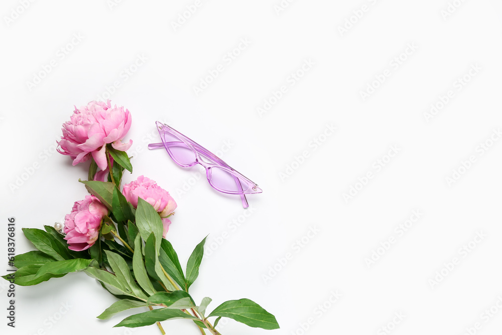 Stylish female sunglasses and beautiful peony flowers on white background