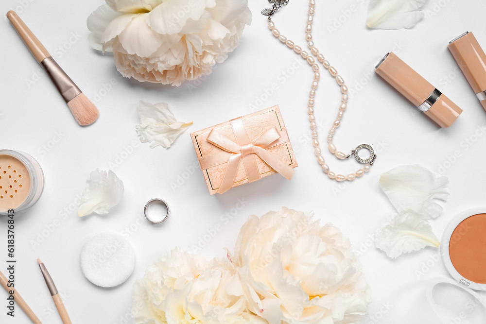 Composition with gift box, female accessories, cosmetics and peony flowers on white background