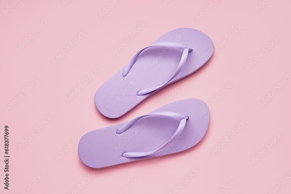 Lilac flip-flops on pink background