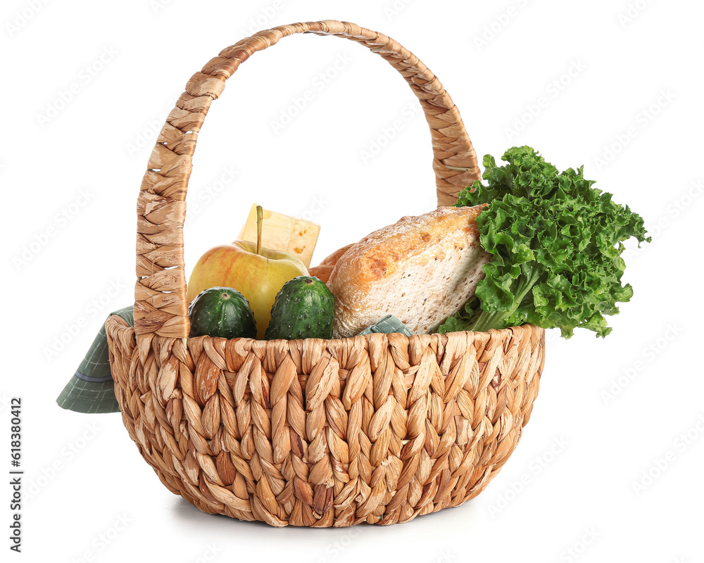 Wicker basket with delicious food for picnic on white background