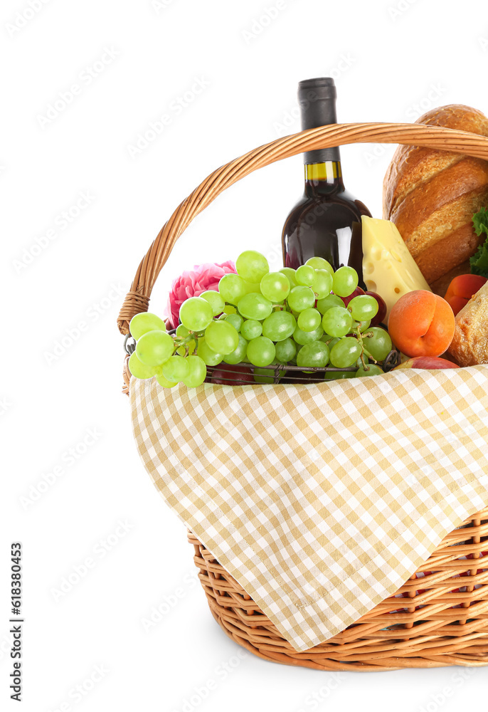 Wicker basket with tasty food for picnic and wine on white background