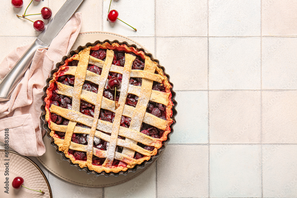 Baking dish with tasty cherry pie on white tile background