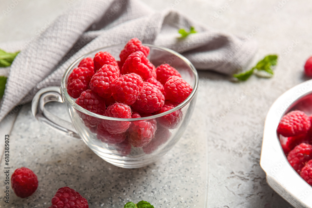 Glass cup with fresh raspberries, closeup