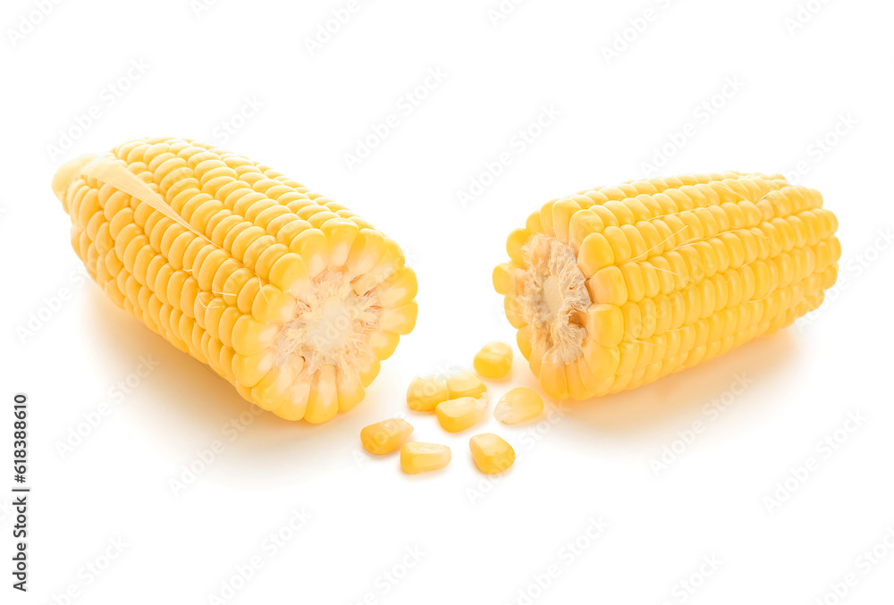 Cut fresh corn cobs and seeds on white background