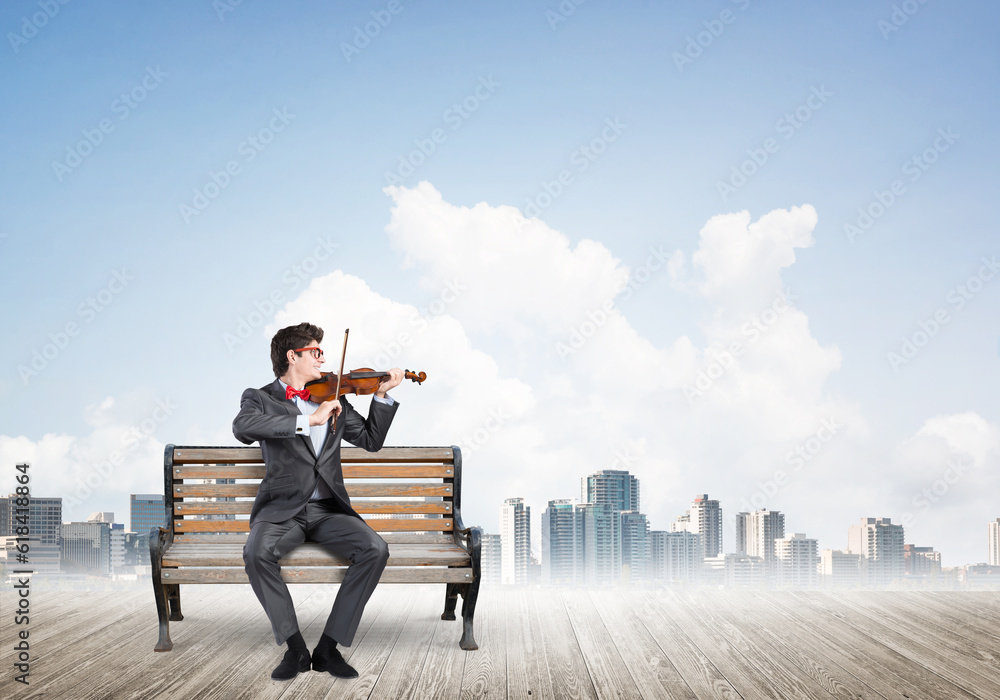 Young businessman plays the violin