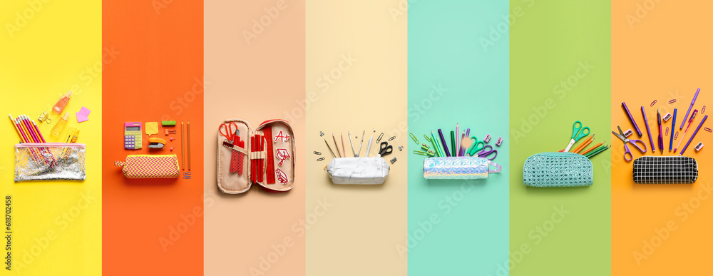 Group of pencil cases with school stationery on color background