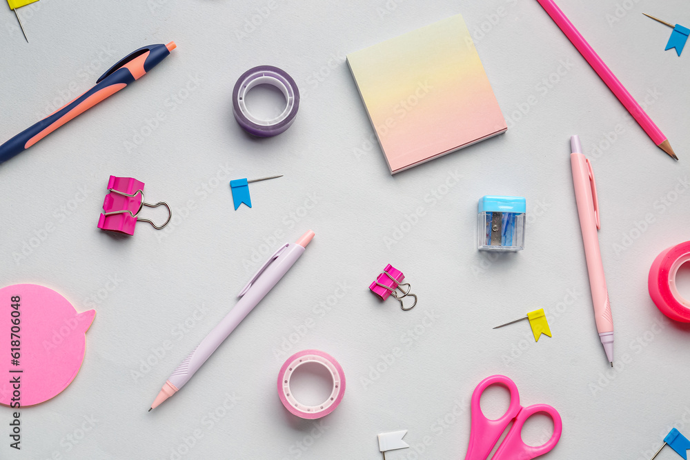 Composition with stationery supplies on grey background